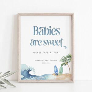 May include: A printable sign for a baby shower with the text "Babies are sweet" in blue script font. The sign also includes a watercolor illustration of a beach scene with waves, palm trees, and surfboards.
