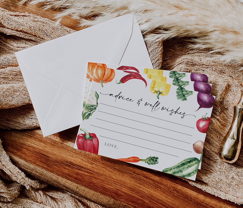 May include: A white card with a colorful vegetable border. The card has lines for writing advice and well wishes. The text "advice & well wishes" is written in black cursive. The card also has the word "LOVE." written in black cursive.
