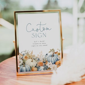 May include: A gold-framed sign with the text "Custom Sign" and "5x7" + "8x10" Create as many signs as you need!"  The sign is decorated with a watercolor illustration of blue and white pumpkins, orange pumpkins, and fall flowers.