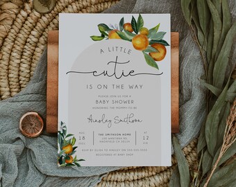 May include: A white baby shower invitation with a watercolor illustration of orange blossoms and the text "A little cutie is on the way". The invitation includes details for the baby shower, including the date, time, location, and RSVP information.