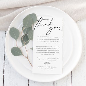 May include: A white thank you card with a handwritten message expressing gratitude to friends and family for attending a wedding. The card includes the couple's names, Ainsley & Michael, and the wedding date, 3rd September 2020.