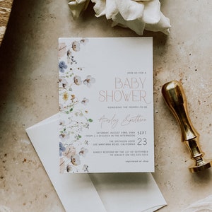 May include: A white baby shower invitation with a floral design in shades of blue, pink, and green. The invitation text reads "Join us for a Baby Shower honoring the mommy-to-be Ainsley Smithson Saturday, August 23rd, 20XX from 1-4 o'clock in the afternoon The Smithson Home 100 Wantirna Road, California 23 Kindly respond by the 1st of September to Ainsley on 555-555-5555 registered at shop"