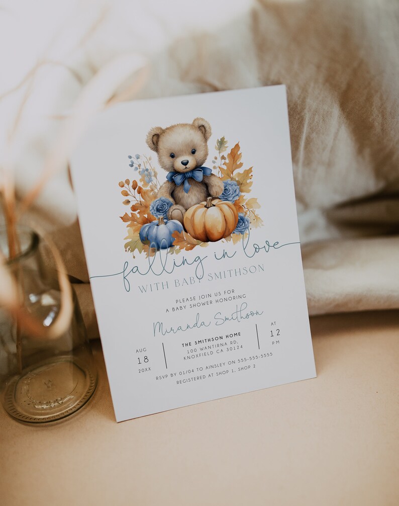 May include: A baby shower invitation featuring a watercolour illustration of a teddy bear holding a pumpkin. The invitation reads "Falling in love with baby Smithson" and includes the date, time, and location of the shower.