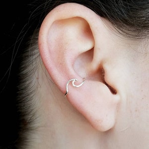 Manguito de oreja de onda, envoltura de oreja del océano, perforación falsa de alambre, ola de playa, manguito de alambre
