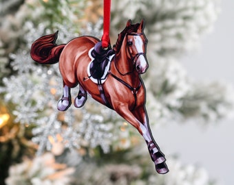 May include: A brown horse ornament with a saddle and bridle, jumping over an obstacle. The ornament is made of wood and is painted in a realistic style. It is a great gift for horse lovers.