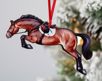 May include: A brown horse ornament with a black saddle and bridle, jumping over an obstacle. The ornament is made of wood and is painted in a realistic style. It is a great gift for horse lovers.