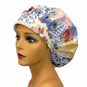 May include: A scrub cap featuring a patchwork design with various fabric patterns including blue and white gingham, floral prints in red, pink, and blue, and yellow striped sections. The cap has a gathered back and a wide, fitted front band.
