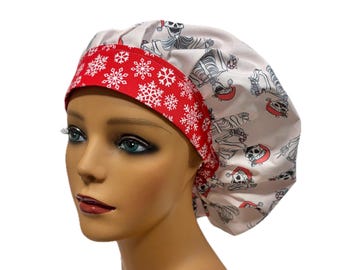 May include: A white and red patterned bouffant surgical scrub cap. The cap features a red band with white snowflakes and a pattern of skeletons wearing Santa hats. The cap is designed to cover the hair during medical procedures.