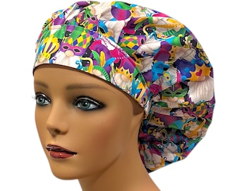 May include: A colorful surgical scrub hat with a Mardi Gras theme. The hat features a white background with a variety of colorful Mardi Gras masks, beads, and other festive decorations.