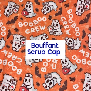 May include: An orange fabric scrub cap featuring a repeating pattern of white ghosts dressed as nurses with medical kits and clipboards, black bats, and spiders. The text BOOBOO CREW is printed in white, and a white box displays Bouffant Scrub Cap.