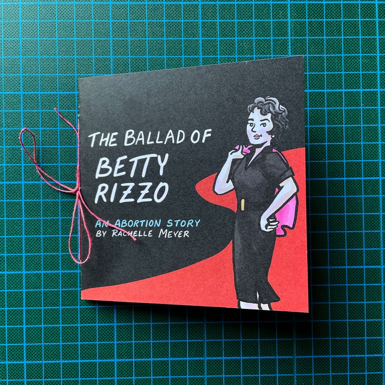 The Ballad of Betty Rizzo, an Abortion Story by Rachelle Meyer, front cover on a cutting mat