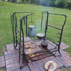 Outdoor cooking area, grilling station, firepit cooking station. Outdoor kitchen,  firepit cooking grill. Backyard cooking fire