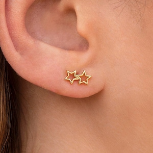 Stud earrings in the shape of two joined hollow stars