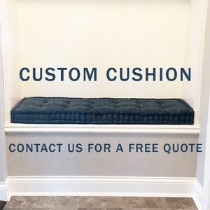 May include: A dark blue custom cushion sits on a white shelf with the text "CUSTOM CUSHION" above it and "CONTACT US FOR A FREE QUOTE" below it.