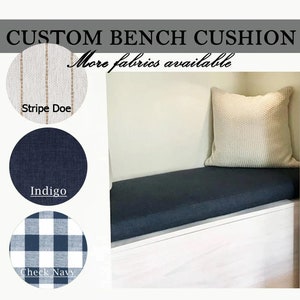 May include: A custom bench cushion in a dark indigo fabric placed on a white bench with a matching throw pillow. Circular fabric swatches are displayed on the left labeled Stripe Doe, Indigo, and Check Navy with the text Custom Bench Cushion.