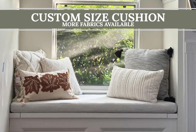 May include: A window seat with a custom-size cushion and several decorative pillows. The pillows are in various shapes and textures, including a rectangular pillow with brown leaf embroidery. The text "CUSTOM SIZE CUSHION" is displayed.