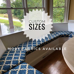 May include: A blue and gold patterned window seat cushion with the text "CUSTOM SIZES" and "MORE FABRICS AVAILABLE".