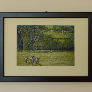 May include: A framed painting of a rural landscape with a small farmhouse in the distance. The foreground features a grassy field with three sheep grazing.