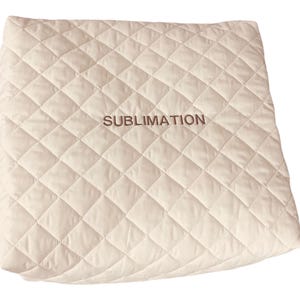 May include: A square, off-white quilted fabric cover featuring a diamond-stitched pattern across its surface. The word SUBLIMATION is embroidered in a dark brown thread in the center of the fabric, providing a clear contrast against the light background.