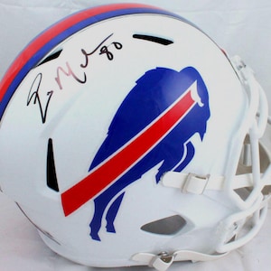May include: White football helmet with a blue and red Buffalo Bills logo. The helmet is signed "R.  Wilson 80".
