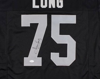 May include: Black football jersey with the name "LONG" and the number "75" on the back. The jersey is signed in silver marker.