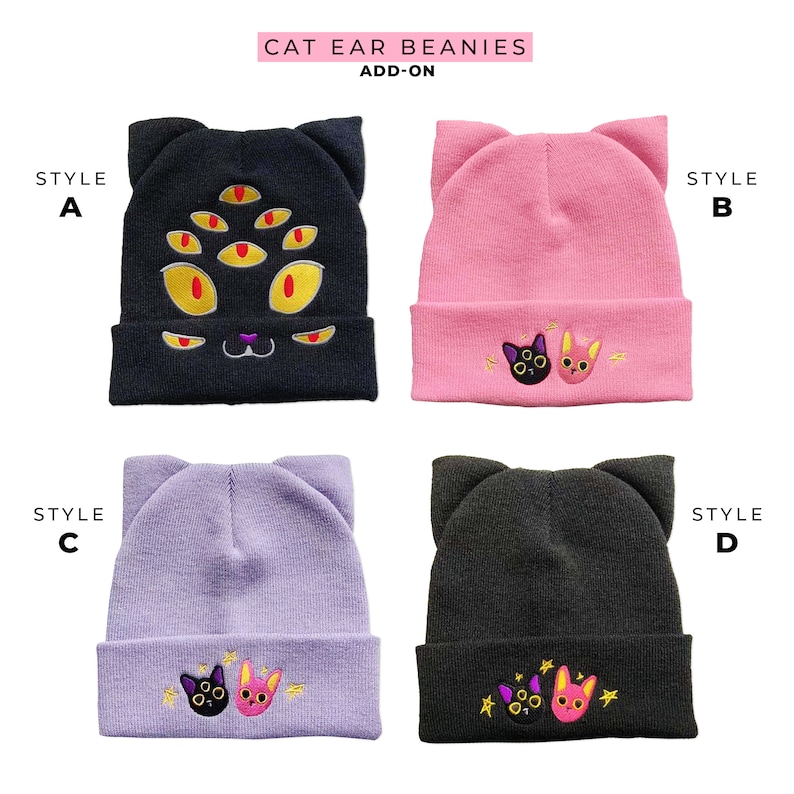 May include: Four different styles of cat ear beanies. Style A is black with a multi-eyed cat face. Style B is pink with two cats embroidered on the front. Style C is lavender with two cats embroidered on the front. Style D is black with two cats embroidered on the front.