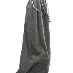 May include: A gray velvet drawstring bag with a white drawstring.