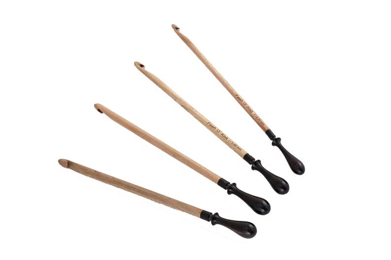 May include: Four wooden crochet hooks with black handles. The hooks are labeled with their sizes: 3.5 mm, 4 mm, 4.5 mm, and 5 mm.
