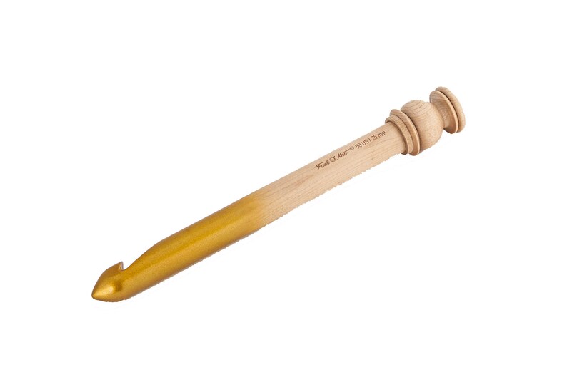 May include: A wooden crochet hook with a gold-colored tip. The hook is 9.5 mm and is labeled "Pony #10 9.5 mm".