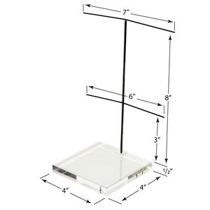 May include: Clear acrylic jewelry display stand. The base is 4 inches square and 1/2 inch thick. The stand is 8 inches tall with two horizontal bars, 7 and 6 inches wide. The stand is designed to hold necklaces and other jewelry items.