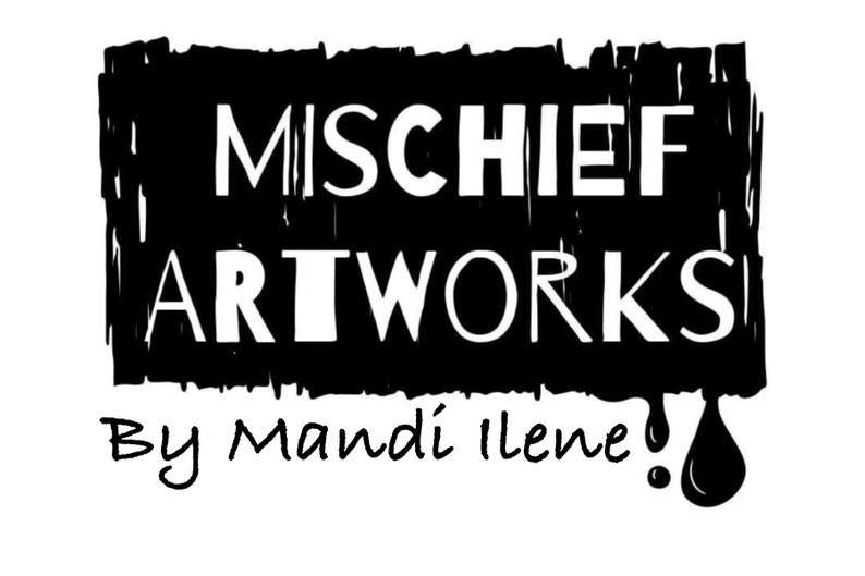 May include: Black and white logo with the text "MISCHIEF ARTWORKS" in a bold, white font. Below the logo, in a handwritten font, is the text "By Mandi Ilene!" with a black paint drip.