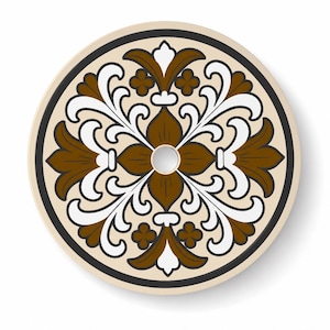 May include: A circular ceramic plate featuring a symmetrical pattern of brown and white stylized floral motifs on a cream background. The design is enclosed by a thin black circular border, and a small circular hole is centered in the middle.