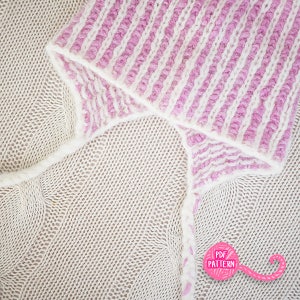 May include: Close-up of a knitted hat with a striped pattern in white and light purple. The hat is folded over a beige knitted fabric. The image includes a pink graphic with the text "PDF PATTERN".