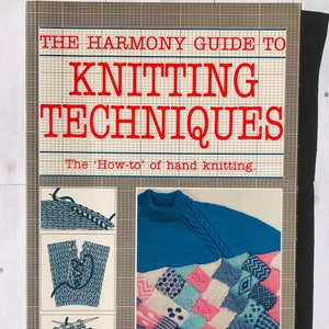May include: A vintage book cover with the title "THE HARMONY GUIDE TO KNITTING TECHNIQUES" in red. The cover includes illustrations of knitting and a photo of a blue knitted sweater and a patchwork blanket. The subtitle reads "The 'How-to' of hand knitting."
