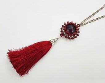 Long red tassel necklace. Glass pendant