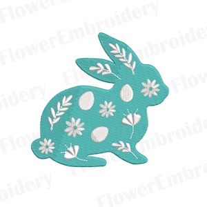 May include: A teal blue Easter bunny silhouette with white floral and egg designs. The bunny is facing the right side of the image.