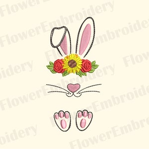 May include: Embroidered design of a white bunny with pink ears, a sunflower and red rose flower crown, a pink nose, and black whiskers. The bunny is sitting with its paws showing.