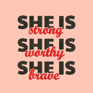 May include: Black text on a pink background reads "She is strong", "She is worthy", and "She is brave".