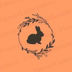 May include: A black silhouette of a rabbit inside a wreath of leaves and flowers. The wreath is a dark brown color and the background is a light orange.