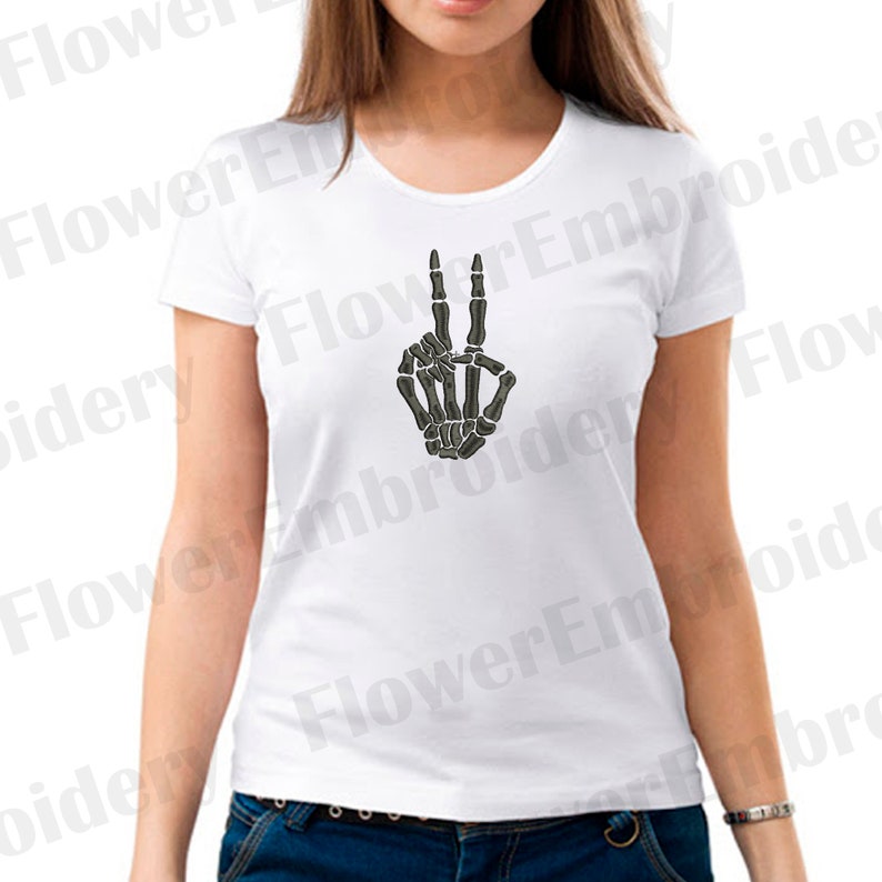 May include: White t-shirt with a black skeleton hand making the peace sign.