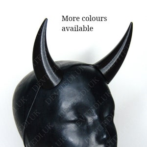 May include: A pair of black devil horns made of plastic. The horns are attached to a headband. More colours are available.