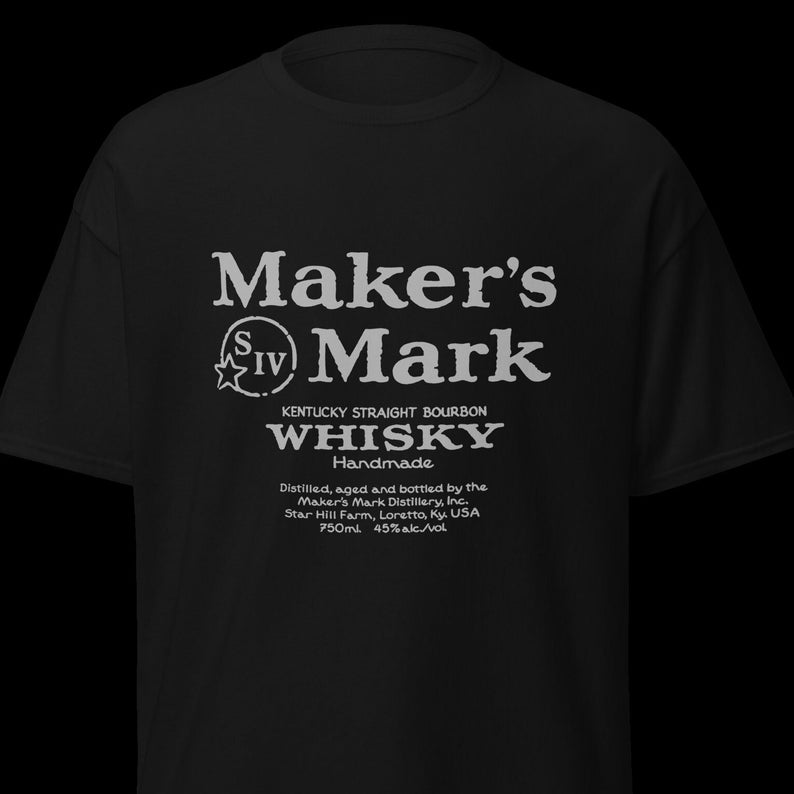 May include: Black t-shirt with a white graphic of the Maker's Mark whiskey label. The label reads "Maker's Mark Kentucky Straight Bourbon Whiskey Handmade Distilled, aged and bottled by the Maker's Mark Distillery, Inc. Star Hill Farm, Loretto, Ky. USA 750ml. 45% alc/vol"