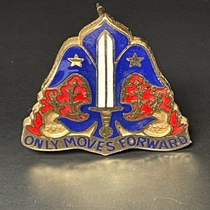 May include: A gold-colored military pin with blue and red enamel. The pin features a sword, two stars, and two oak leaves. The text "ONLY MOVES FORWARD" is inscribed on the bottom.