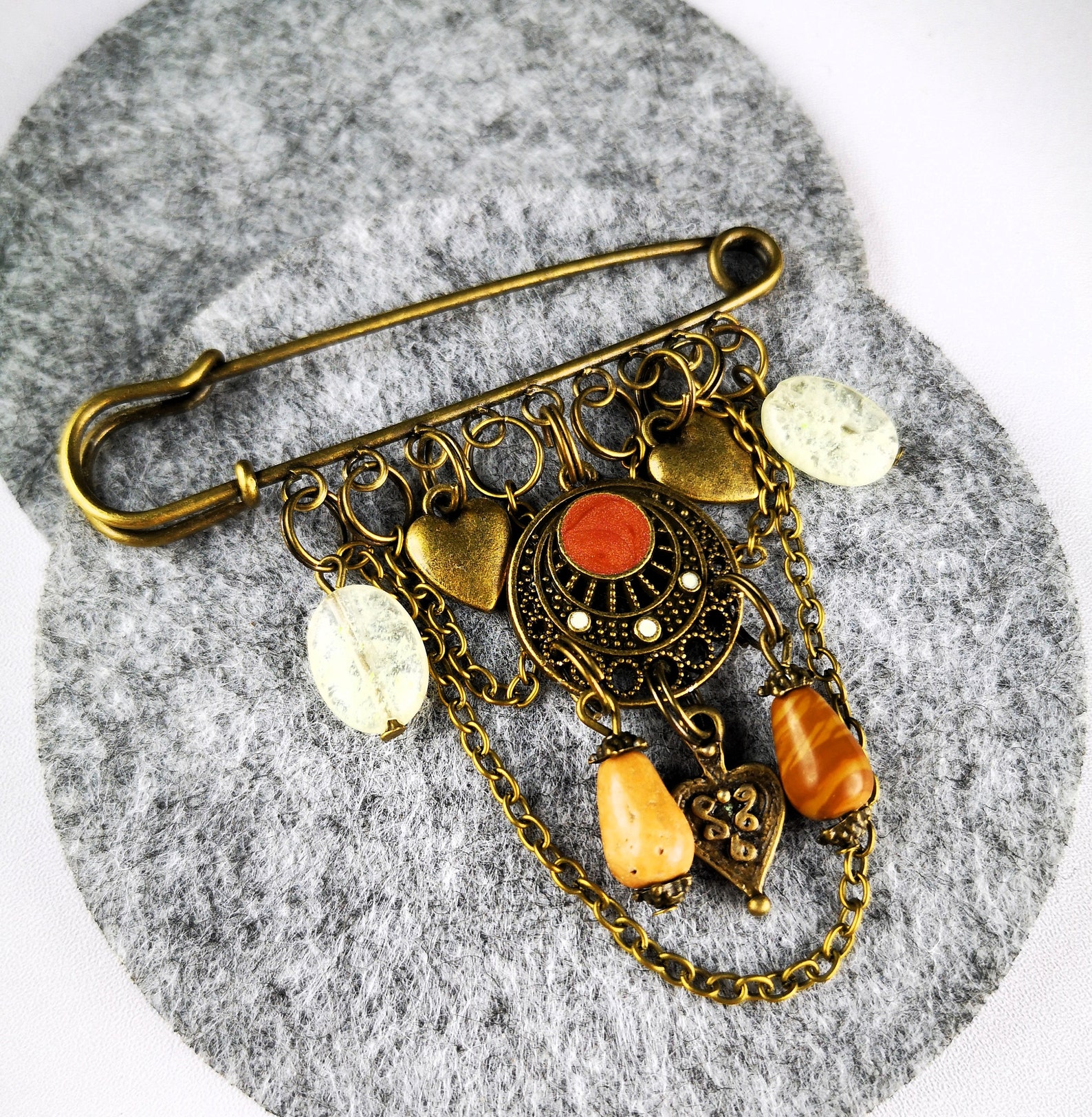 A gold-toned safety pin brooch.