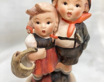 Surprise Hummel figurine/boy and girl statuette