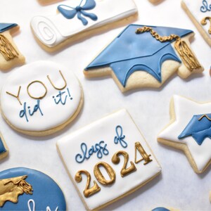- White star shaped cookie with a royal blue graduation cap design with a gold tassel

- Royal blue graduation cap cookie with a gold tassel