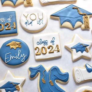 White square shaped cookie with "class of 2024" written on it, with the "class of" in royal blue and "2024" in gold