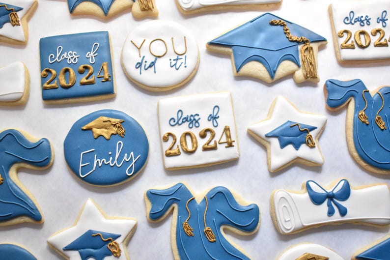 White square shaped cookie with "class of 2024" written on it, with the "class of" in royal blue and "2024" in gold