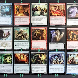 May include: A collection of fifteen Magic: The Gathering trading cards. The cards feature various fantasy art illustrations, including creatures, spells, and artifacts. The cards are in English and have different mana symbols and text.