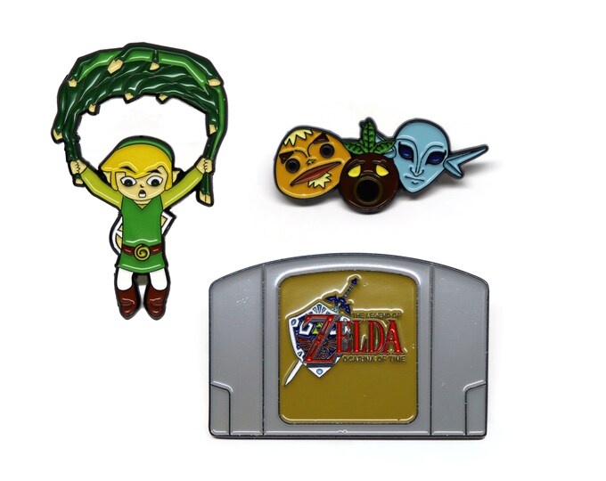 Legend of Zelda N64 Ocarina of Time cartridge, majora's mask set, and wind waker flying deku leaf Link enamel pin bundle
